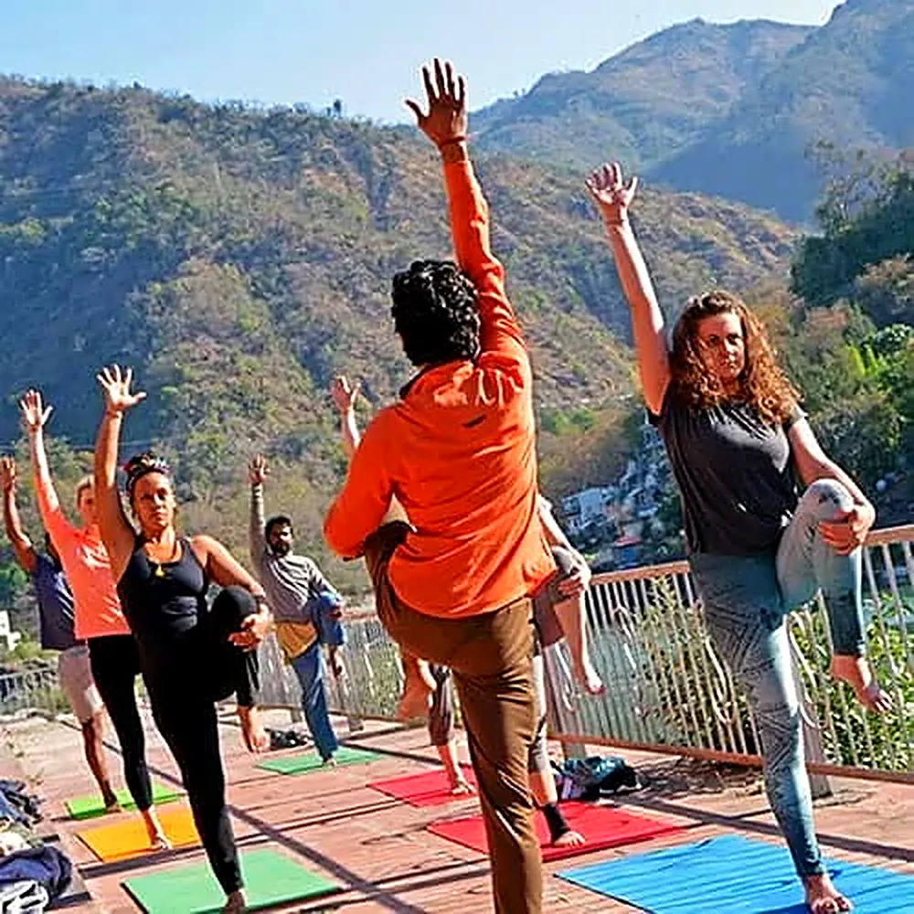 100-hour teacher trainees practicing a group asana pose in Rishikesh