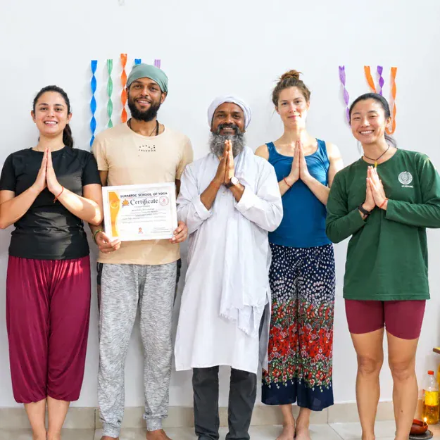 Acharya Siddhant mentoring yoga students in traditional yogashala setting