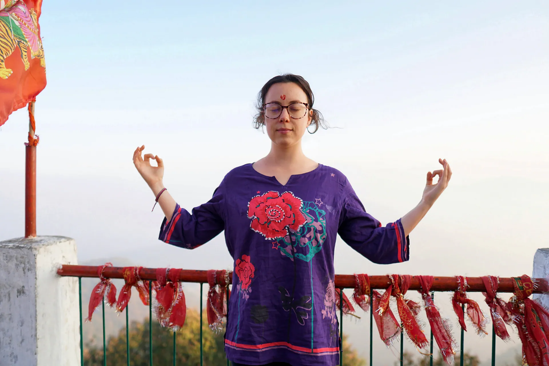 Busy professional practicing Gyan Mudra meditation on a Rishikesh hilltop