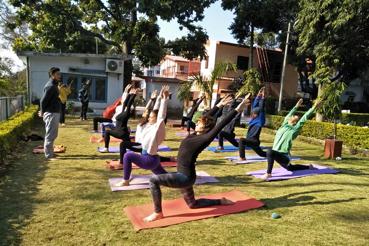 Experienced yoga teacher deepening practice by the Ganges in Rishikesh