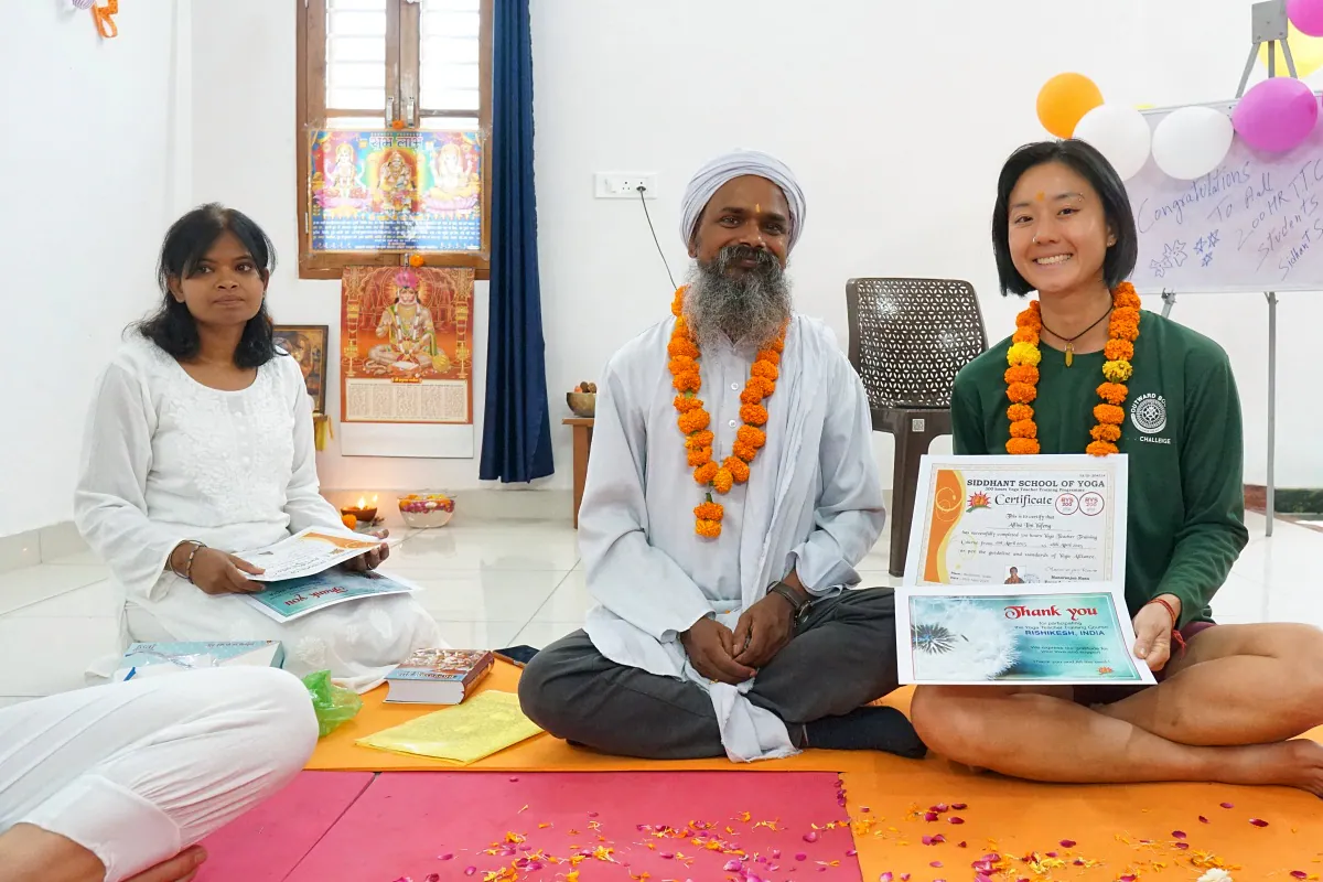 Student receiving their yoga teacher training certificate at Siddhant School of Yoga
