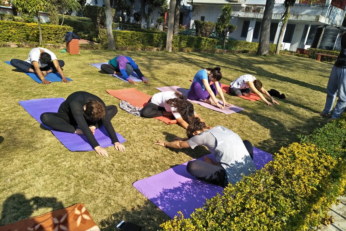 Students resting in a quiet relaxation practice at the ashram