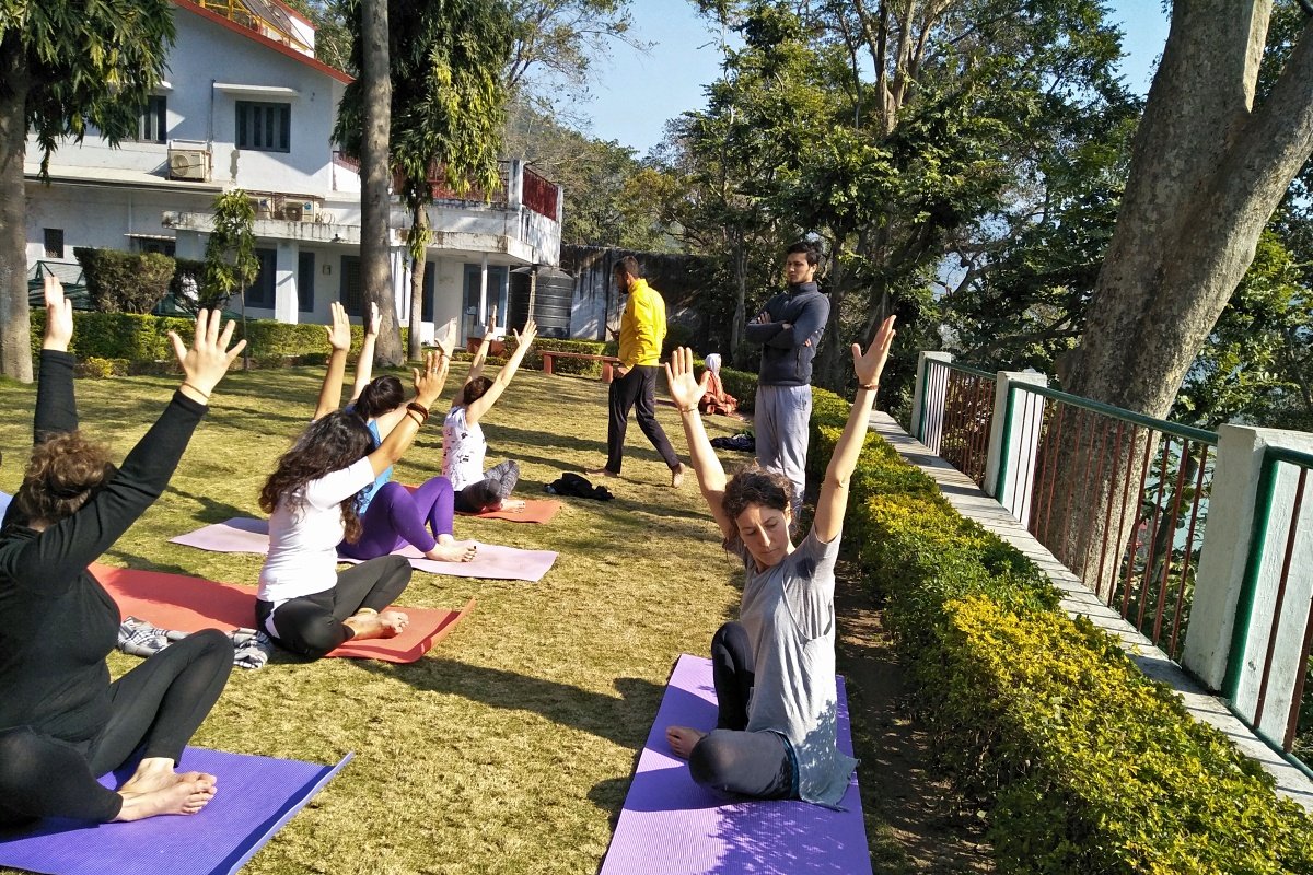 A trainee teacher leading fellow students in an outdoor class
