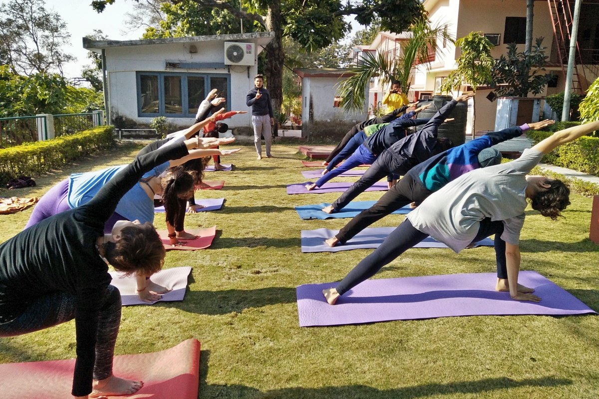 Side angle pose in a garden yoga class