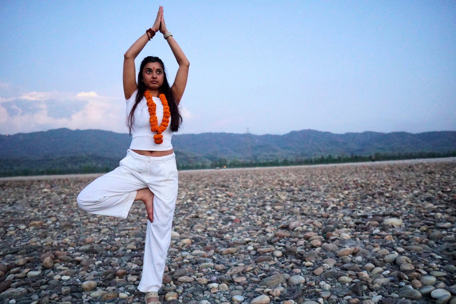 Tree pose (Vrikshasana) practice on the Ganga riverbank