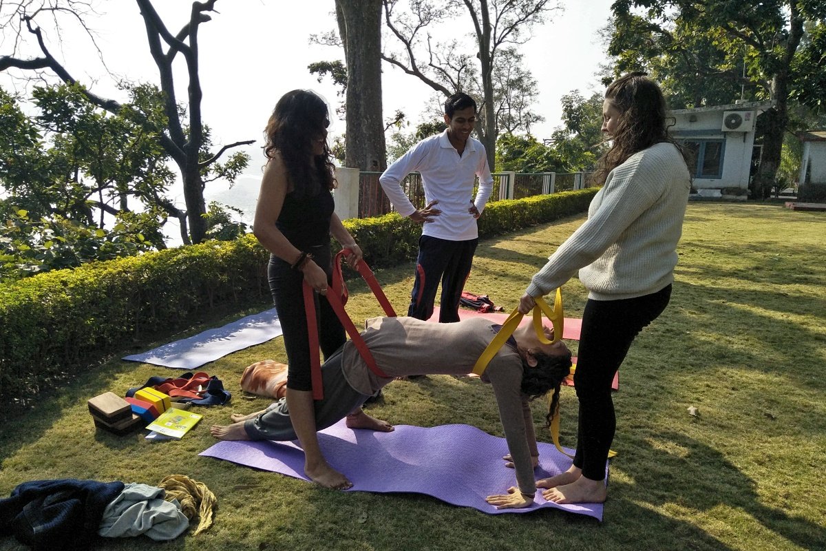 Alignment and adjustment class with straps during the yoga TTC