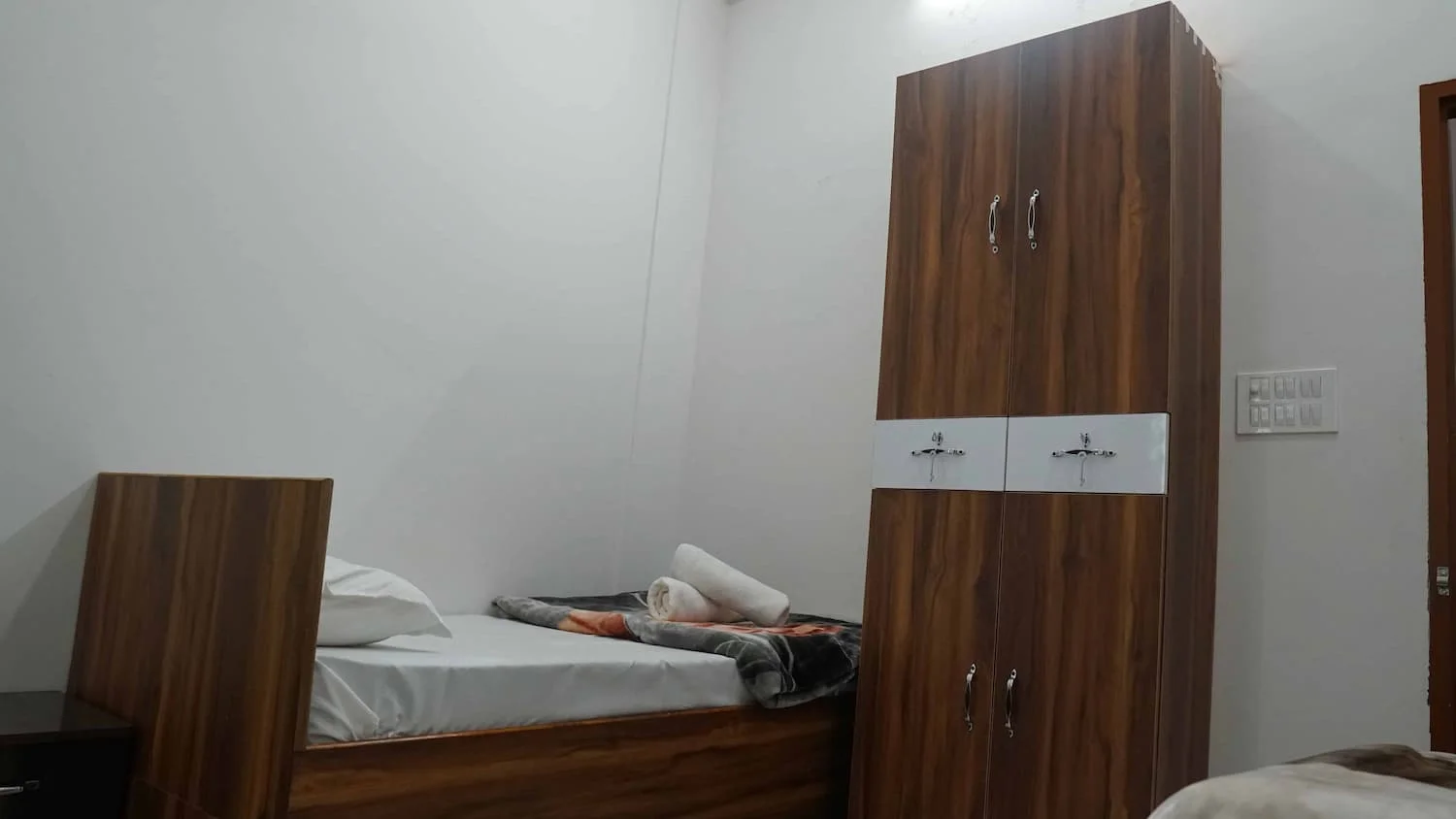 Comfortable room with bed and wardrobe at Siddhant School of Yoga