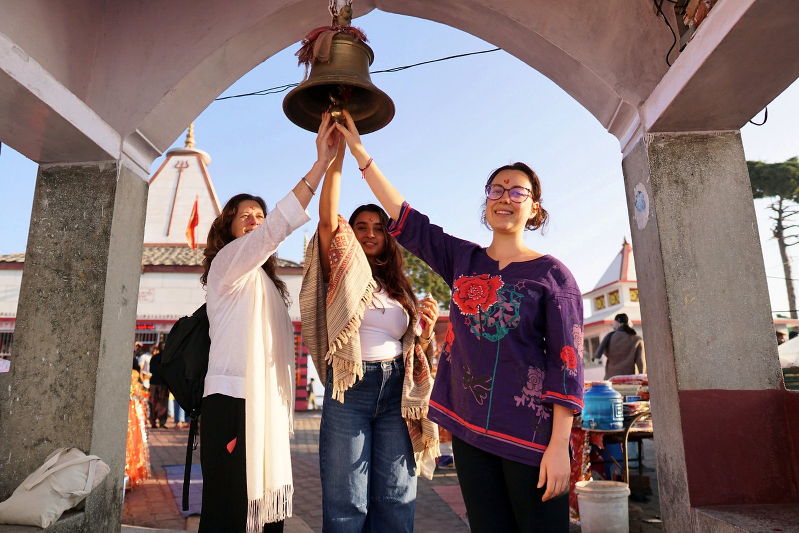 Students ringing the bell at Kunjapuri temple excursion