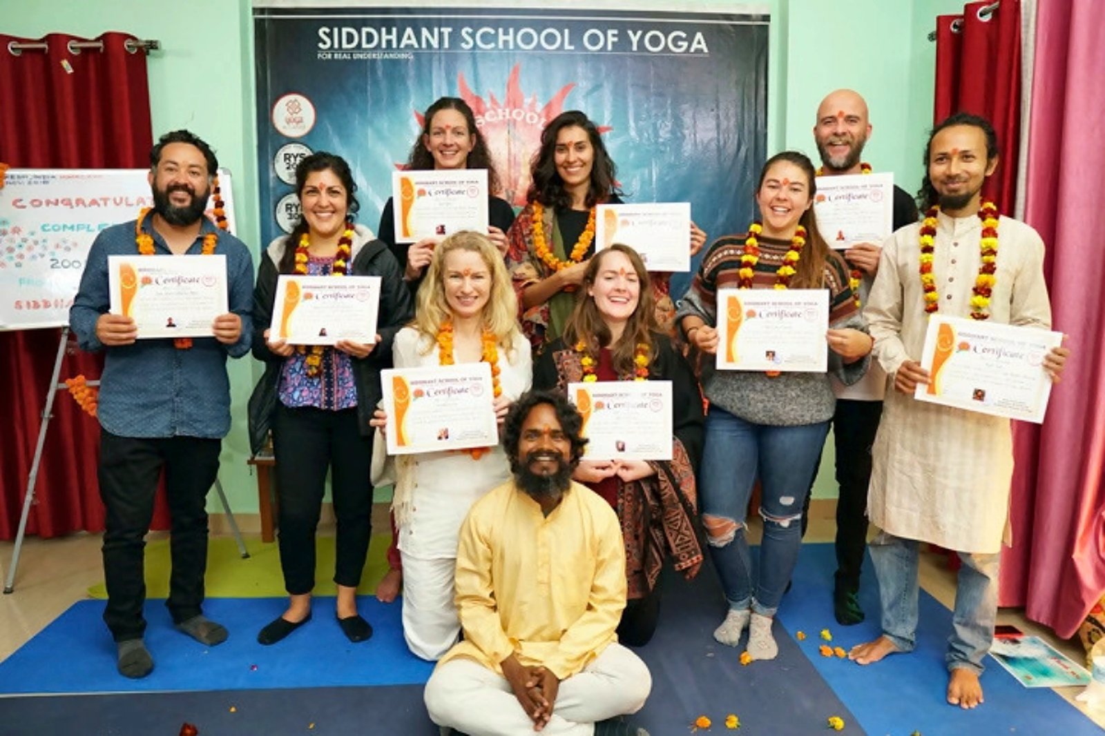 Yoga TTC graduates with their certificates at Siddhant School of Yoga