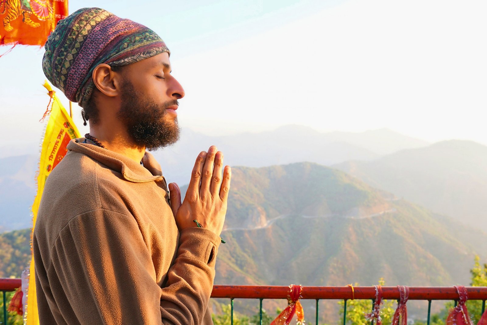 Prayer pose at sunrise with the Himalayas in the background